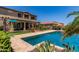 Beautiful backyard with a sparkling pool, lush landscaping, and covered patio, perfect for outdoor entertaining at 19427 W Colter St, Litchfield Park, AZ 85340