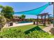 Beautiful backyard pool with patio, seating, and lush landscaping, perfect for relaxation and outdoor enjoyment at 19427 W Colter St, Litchfield Park, AZ 85340