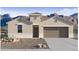 Inviting single-story home boasting desert landscaping, a two-car garage and neutral color palette at 2118 W Starfire Ave, Apache Junction, AZ 85120