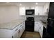 Bright kitchen featuring white cabinets, granite counters, and modern black appliances at 2144 E Center Ln # 3, Tempe, AZ 85281