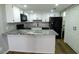 Updated kitchen features sleek, granite countertops, modern appliances and white cabinetry at 2144 E Center Ln # 3, Tempe, AZ 85281