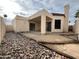 View of the backyard showing the covered patio, rock landscaping, and private courtyard at 2169 E Bishop Dr, Tempe, AZ 85282