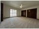 Bedroom featuring neutral carpet, a ceiling fan, and double closets at 2169 E Bishop Dr, Tempe, AZ 85282