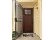 Inviting front entryway with a secured screen door, welcome mat and decorative glass on the rich brown door at 2169 E Bishop Dr, Tempe, AZ 85282