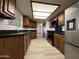 Well-lit kitchen featuring wooden cabinets, black countertops, modern appliances, and a stainless steel refrigerator at 2169 E Bishop Dr, Tempe, AZ 85282