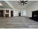Spacious living room boasting wood-look tile floors, a ceiling fan, and a fireplace at 2169 E Bishop Dr, Tempe, AZ 85282