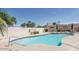 Community pool featuring lounge chairs and umbrellas for relaxation at 2169 E Bishop Dr, Tempe, AZ 85282
