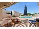Community pool area with picnic tables, lounge chairs, umbrellas and lush greenery at 2169 E Bishop Dr, Tempe, AZ 85282