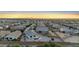 This aerial view shows a community with fenced yards and several properties with swimming pools at 21797 N 259Th Ave, Buckeye, AZ 85396