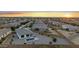 This aerial view shows a community with fenced yards and several properties with swimming pools at 21797 N 259Th Ave, Buckeye, AZ 85396