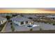 This aerial view shows a community with fenced yards and several properties with swimming pools at 21797 N 259Th Ave, Buckeye, AZ 85396