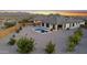 This aerial view showcases a backyard with a pool, desert landscaping, and a covered patio at 21797 N 259Th Ave, Buckeye, AZ 85396