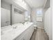 Bright bathroom with a double vanity, ample counter space, and a shower-tub combination offers a functional space at 21797 N 259Th Ave, Buckeye, AZ 85396