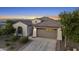 This aerial shows the front exterior with a tile roof, desert landscaping and a wide driveway at 21797 N 259Th Ave, Buckeye, AZ 85396