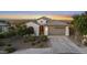 This aerial shows the front exterior with a tile roof, desert landscaping and a wide driveway at 21797 N 259Th Ave, Buckeye, AZ 85396