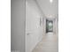 Bright hallway with wood-look tile and white doors leads to the home's entrance and other rooms at 21797 N 259Th Ave, Buckeye, AZ 85396