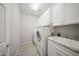 Functional laundry room featuring a sink, and ample cabinet space for organized laundry tasks at 21797 N 259Th Ave, Buckeye, AZ 85396