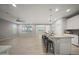 View of the open floorplan showcasing the living and kitchen space with seating at 21797 N 259Th Ave, Buckeye, AZ 85396