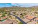 Expansive aerial view of desert homes with terracotta tile roofs and mountain views in a luxury neighborhood at 2255 N Hillridge --, Mesa, AZ 85207