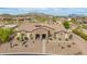 Expansive aerial view of a custom home in the Mountain Bridge community, showcasing desert landscaping and mountain views at 2255 N Hillridge --, Mesa, AZ 85207