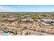 Scenic aerial shot of a desert community featuring luxurious homes, each with pristine pools and beautifully landscaped yards at 2255 N Hillridge --, Mesa, AZ 85207