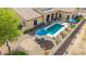 This backyard features a sparkling pool, covered patio and stylish patio furniture at 2255 N Hillridge --, Mesa, AZ 85207
