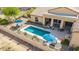 This backyard features a sparkling pool, covered patio and stylish patio furniture at 2255 N Hillridge --, Mesa, AZ 85207