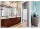 Bathroom with double sinks, large mirror, tiled floor, and adjacent toilet and shower area at 2255 N Hillridge --, Mesa, AZ 85207