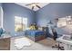 Bright bedroom with natural light from large windows, carpet flooring, and fun decor at 2255 N Hillridge --, Mesa, AZ 85207