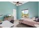 Bedroom featuring aqua-painted walls, ceiling fan, and large window with desert landscape views at 2255 N Hillridge --, Mesa, AZ 85207