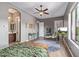 Spacious bedroom with a ceiling fan, TV, desk, chair, and view to bathroom through an archway at 2255 N Hillridge --, Mesa, AZ 85207