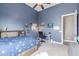 A blue walled bedroom features a twin bed with a blue comforter and a ceiling fan at 2255 N Hillridge --, Mesa, AZ 85207