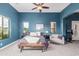 Stylish bedroom featuring blue walls, carpeted floor, and a ceiling fan with attached lighting at 2255 N Hillridge --, Mesa, AZ 85207