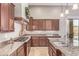 Well-equipped kitchen featuring granite countertops, a cooktop, and wood cabinets at 2255 N Hillridge --, Mesa, AZ 85207