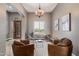 Inviting living room with stylish chandelier, comfortable seating, and views of the outdoors at 2255 N Hillridge --, Mesa, AZ 85207