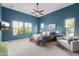 Bright main bedroom with a ceiling fan, carpet, and large windows showcasing stunning backyard and pool views at 2255 N Hillridge --, Mesa, AZ 85207