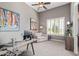 Bright home office space featuring a high ceiling, large window with plantation shutters, and a sofa at 2255 N Hillridge --, Mesa, AZ 85207