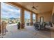 Covered patio with several ceiling fans, stone columns, outdoor furniture, and a view of the pool at 2255 N Hillridge --, Mesa, AZ 85207