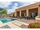 Inviting pool with patio featuring outdoor kitchen and seating, complemented by desert landscaping and a serene atmosphere at 2255 N Hillridge --, Mesa, AZ 85207