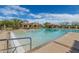 A beautiful pool with a beach-like entry next to the clubhouse and shaded seating areas creating a resort-like atmosphere at 2255 N Hillridge --, Mesa, AZ 85207