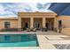 Back yard showcasing the pool, desert landscaping, and outdoor living space with multiple seating areas at 2255 N Hillridge --, Mesa, AZ 85207