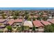 Aerial view of a desert community with mountain views and turf at 2421 W Romley Rd, Phoenix, AZ 85041