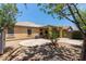 The private backyard features desert landscaping and a covered patio at 2421 W Romley Rd, Phoenix, AZ 85041