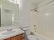This bathroom features a tub with shower, a vanity, and a commode at 2421 W Romley Rd, Phoenix, AZ 85041