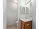 Cozy bathroom with vanity, mirror, light fixture, and white toilet at 2421 W Romley Rd, Phoenix, AZ 85041