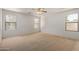 Well lit bedroom with three windows and a ceiling fan fixture at 2421 W Romley Rd, Phoenix, AZ 85041