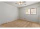 This bedroom features a ceiling fan, a window and is ready to be customized at 2421 W Romley Rd, Phoenix, AZ 85041