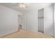Bedroom with neutral carpet, closet, and door leading to an adjacent bathroom at 2421 W Romley Rd, Phoenix, AZ 85041