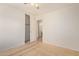 Bedroom with neutral carpet, closet, and door leading to an adjacent bathroom at 2421 W Romley Rd, Phoenix, AZ 85041