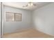 This bedroom features a ceiling fan, a window and is ready to be customized at 2421 W Romley Rd, Phoenix, AZ 85041